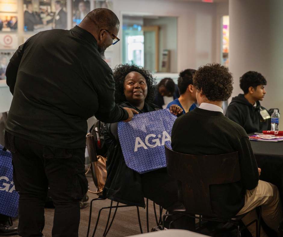 Chris Reynolds, Community Service and Meetings & Events Chair of AGA Philadelphia Chapter, handing out AGA-branded bags